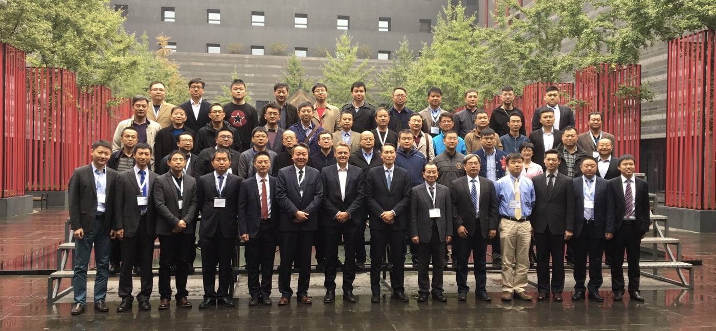 Group photo of neurosurgery delegates in a courtyard, with Dr Gert Tollesson in the front row